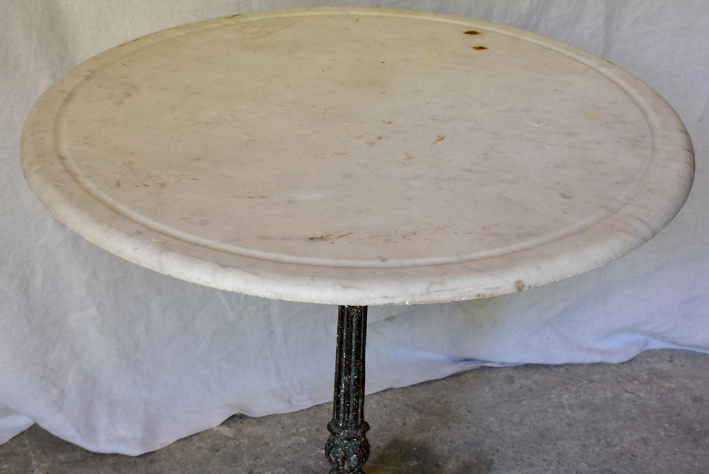 Late 19th Century round French table with marble top and cast iron base 31"