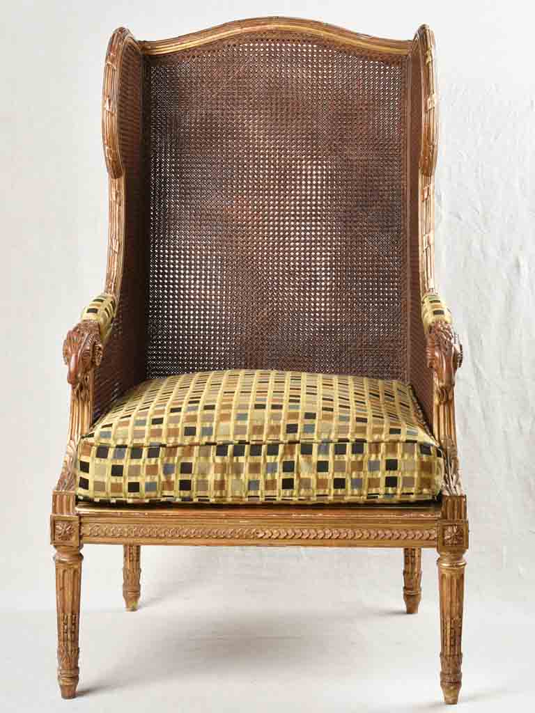 Large cane bergere armchair - ram's heads - 19th century