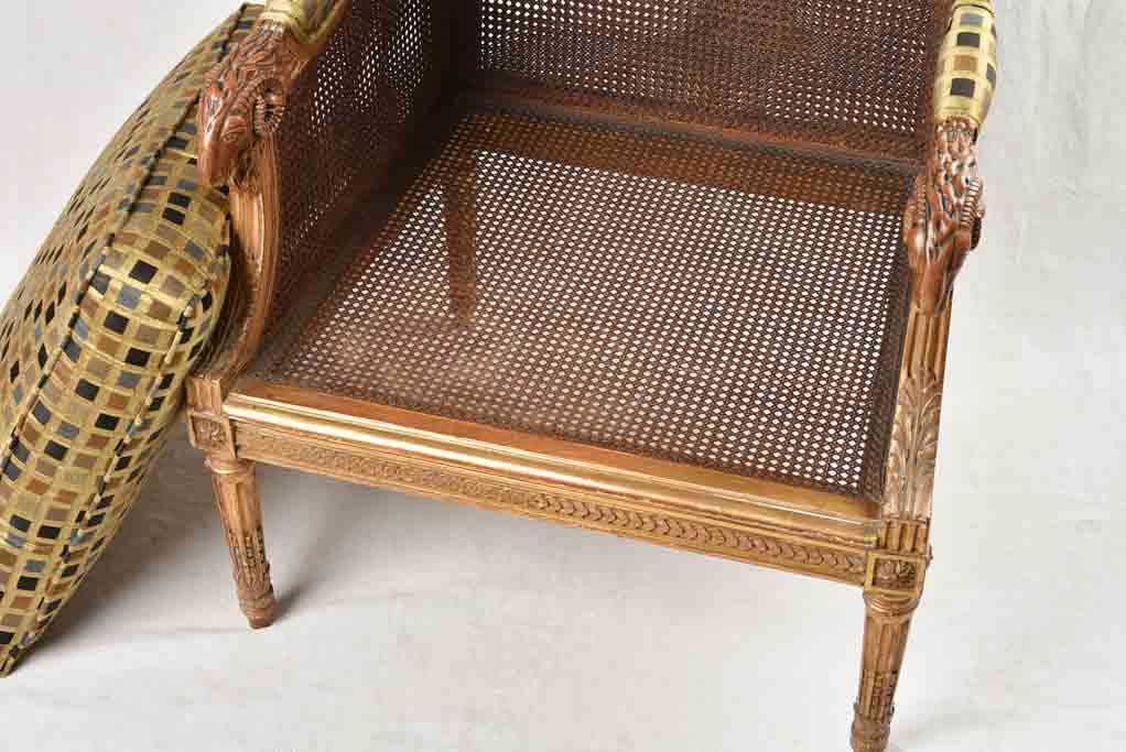 Large cane bergere armchair - ram's heads - 19th century