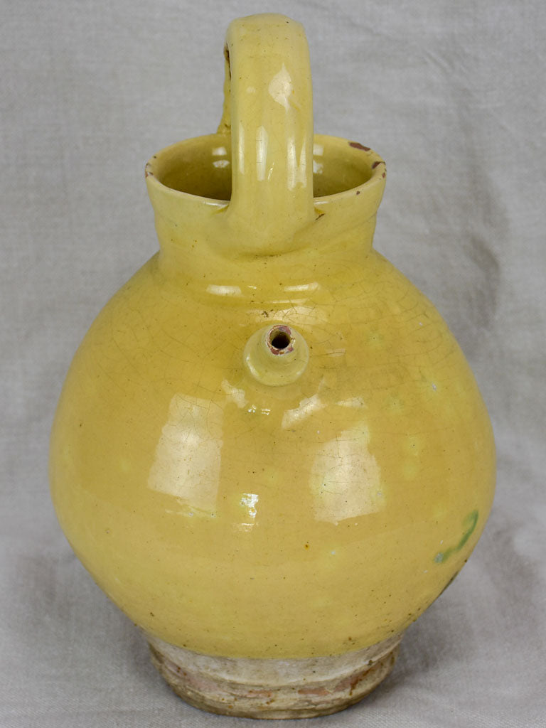 Antique French water pitcher with pale yellow glaze