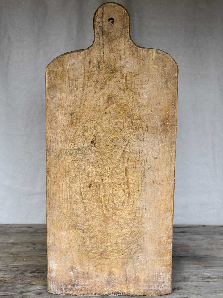 Large antique French cutting board with rounded handle and shoulders