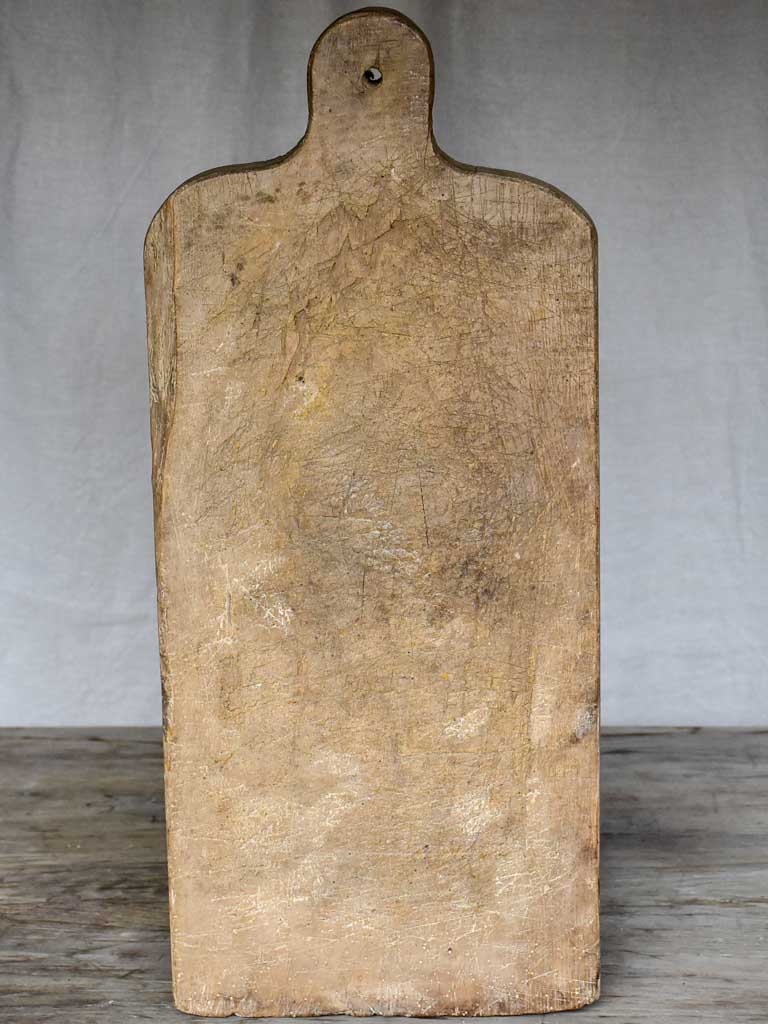 Large antique French cutting board with rounded handle and shoulders