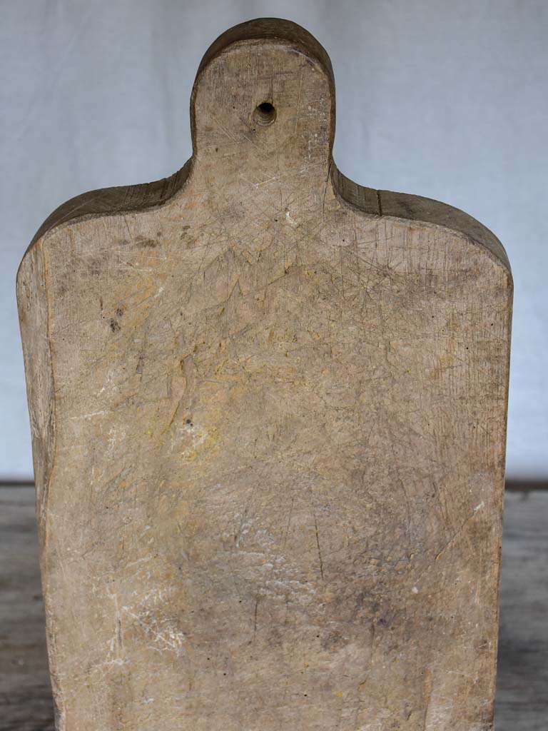Large antique French cutting board with rounded handle and shoulders