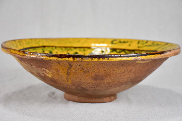 Antique folk art terracotta bowl with yellow glaze 11½"