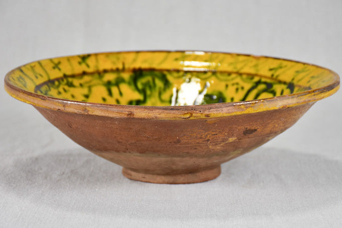 Antique folk art terracotta bowl with yellow glaze 11½"
