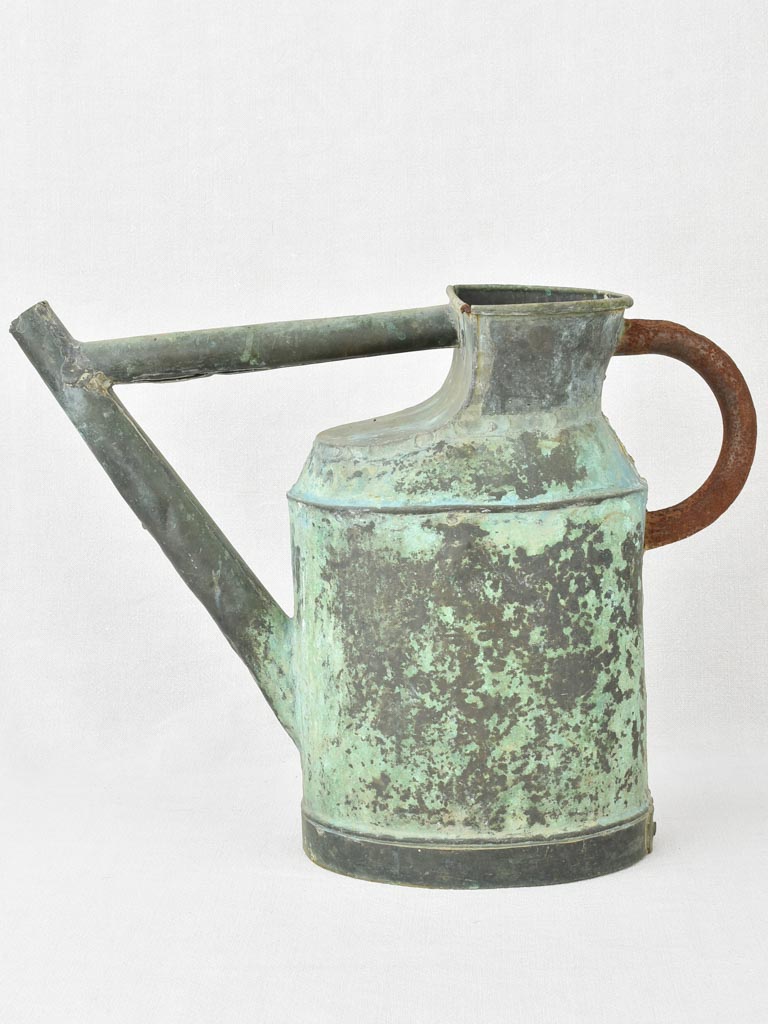 Antique French watering can with verdigris patina