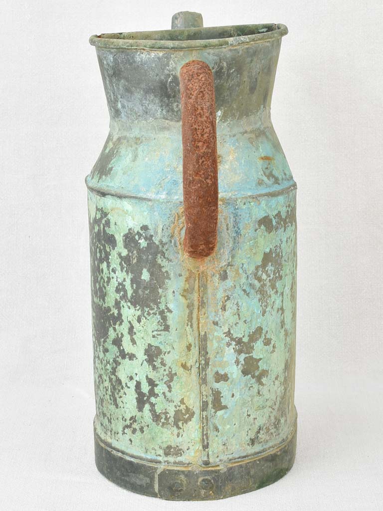 Antique French watering can with verdigris patina