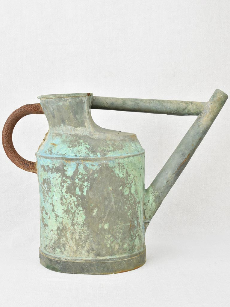 Antique French watering can with verdigris patina