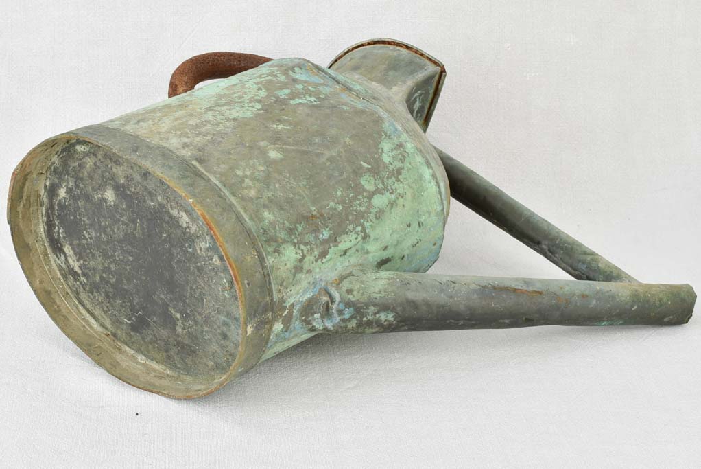 Antique French watering can with verdigris patina