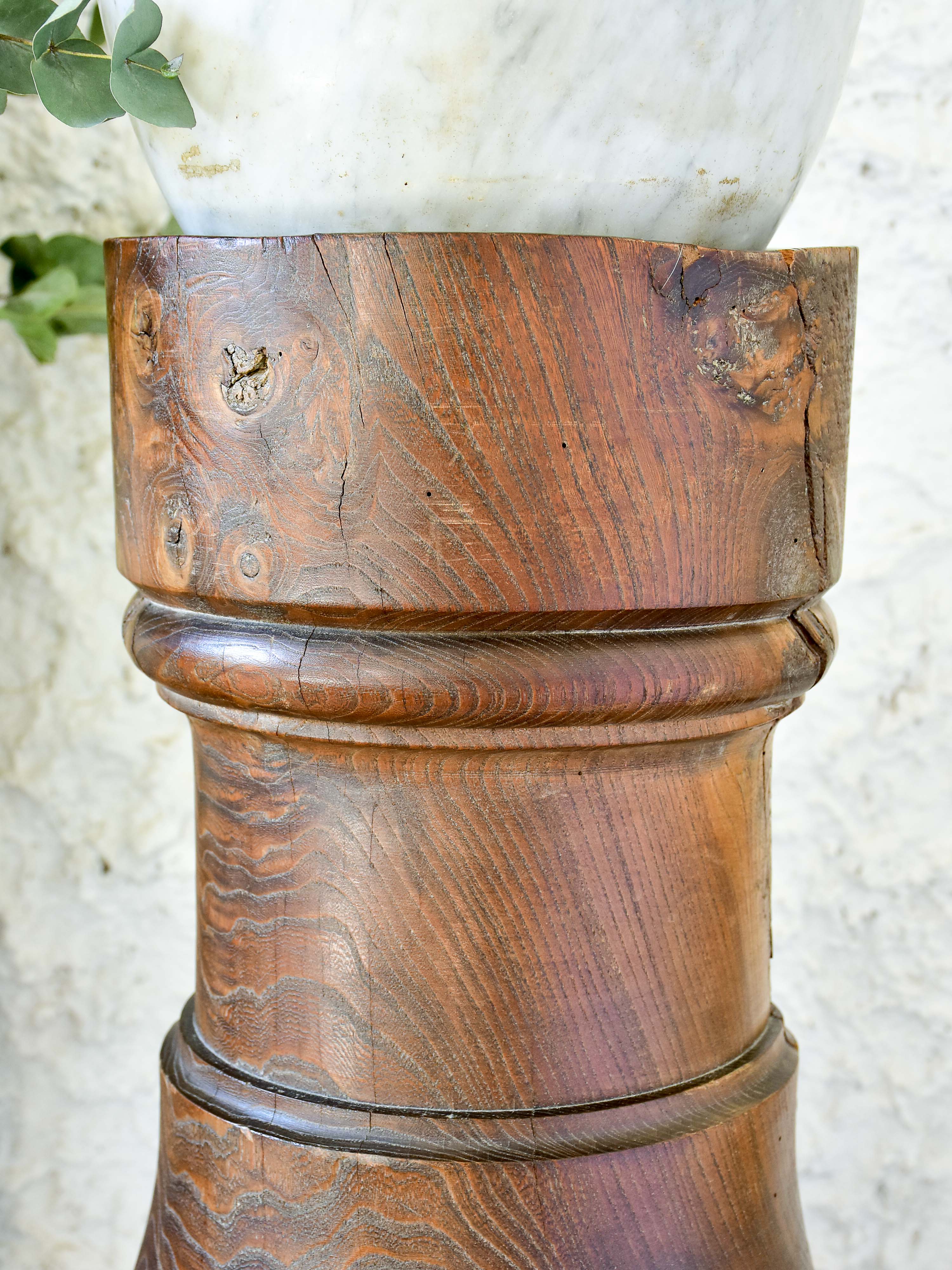 Marble mortar with double headed pestle in carved timber stand