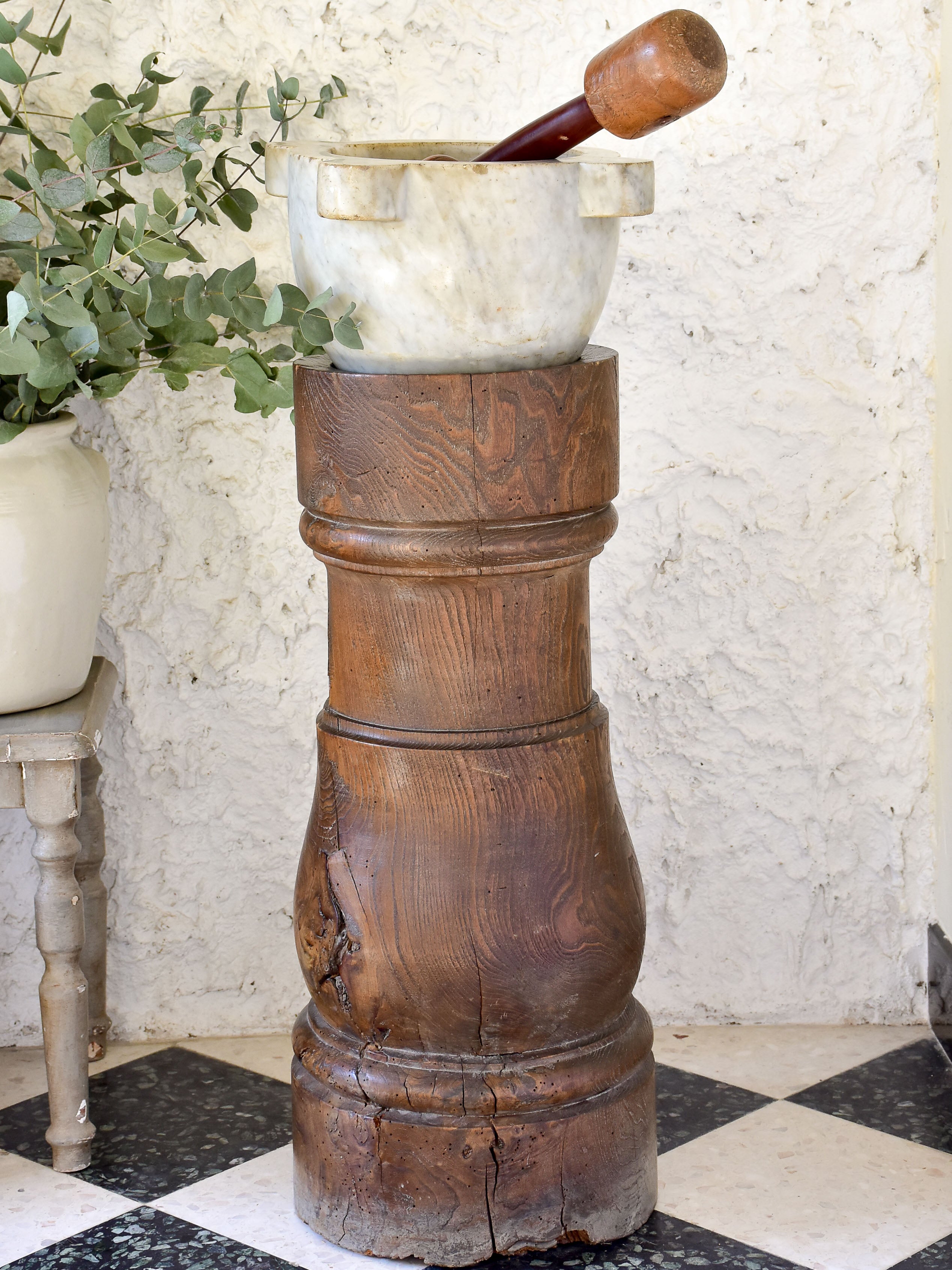 Marble mortar with double headed pestle in carved timber stand