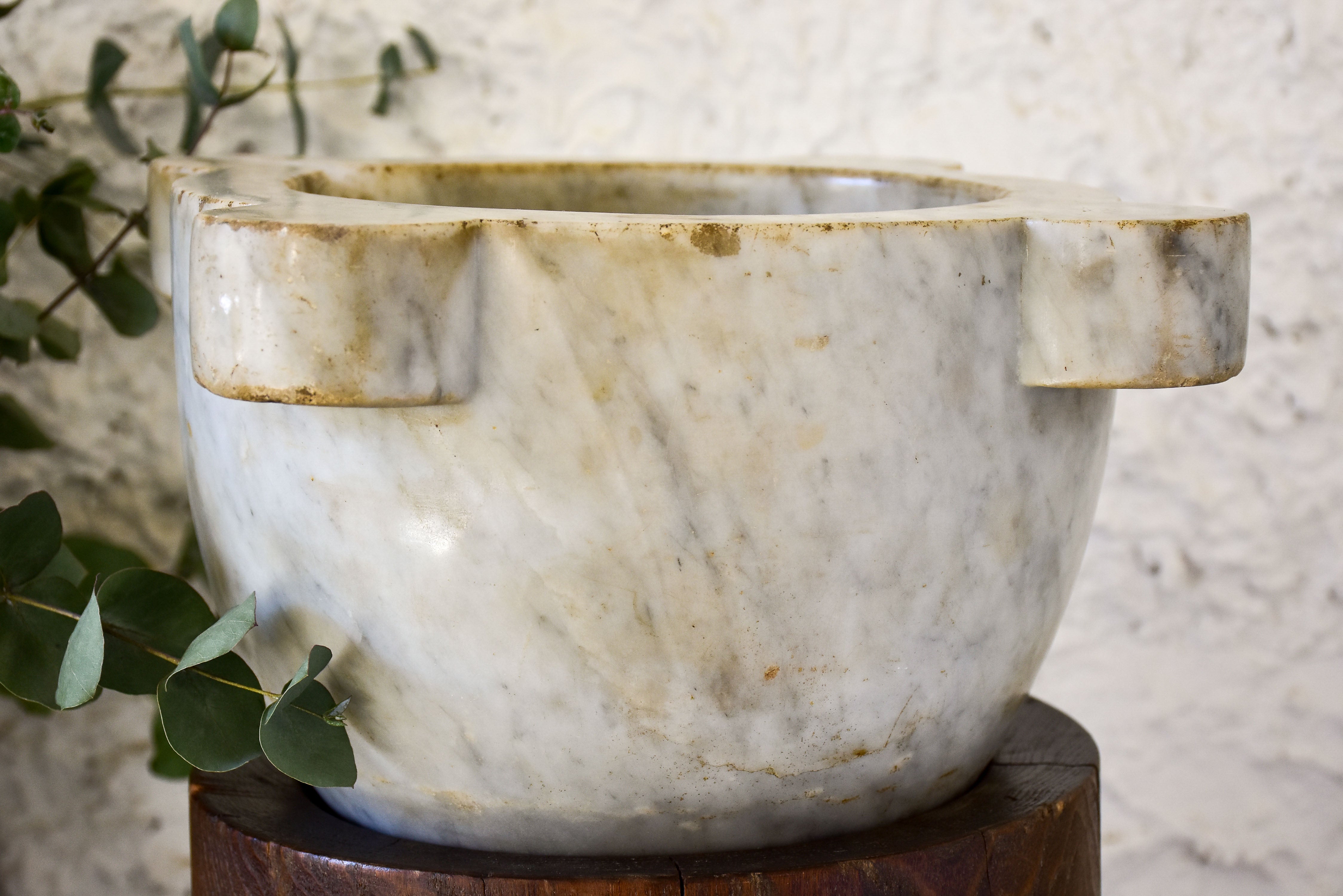 Marble mortar with double headed pestle in carved timber stand
