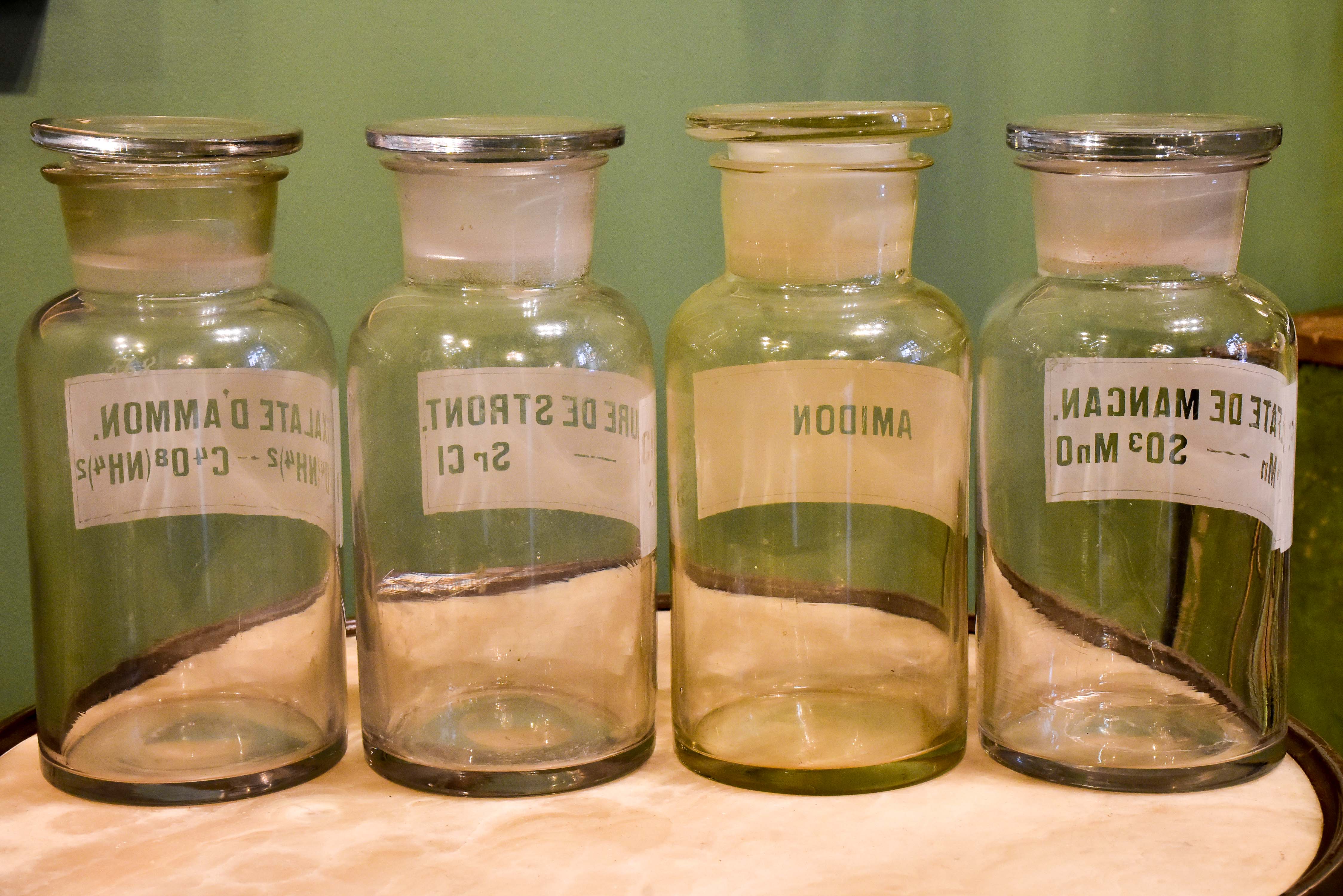 Four antique French apothecary glass jars