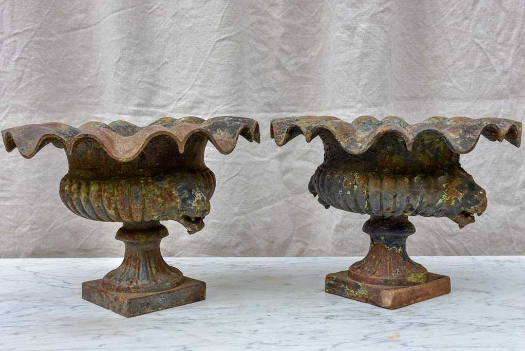 Pair of 19th Century cast iron Medici urns with lion's heads