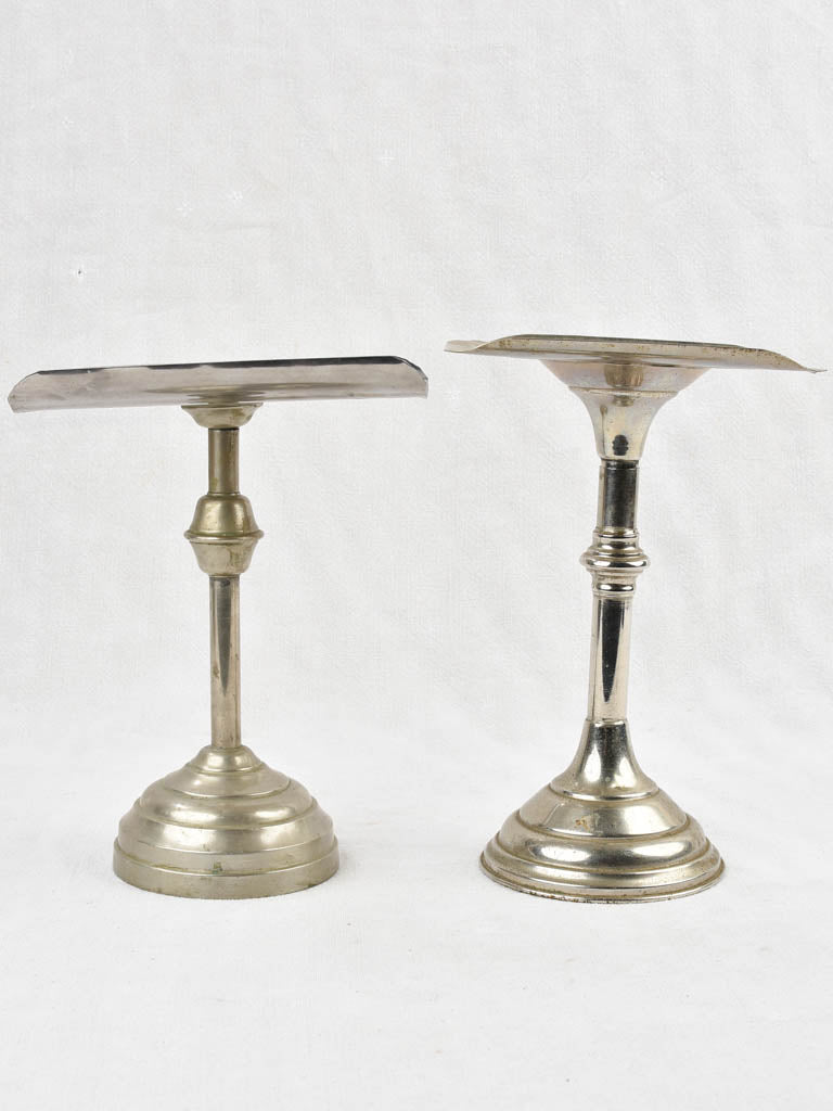 Two antique footed coin trays from a counter