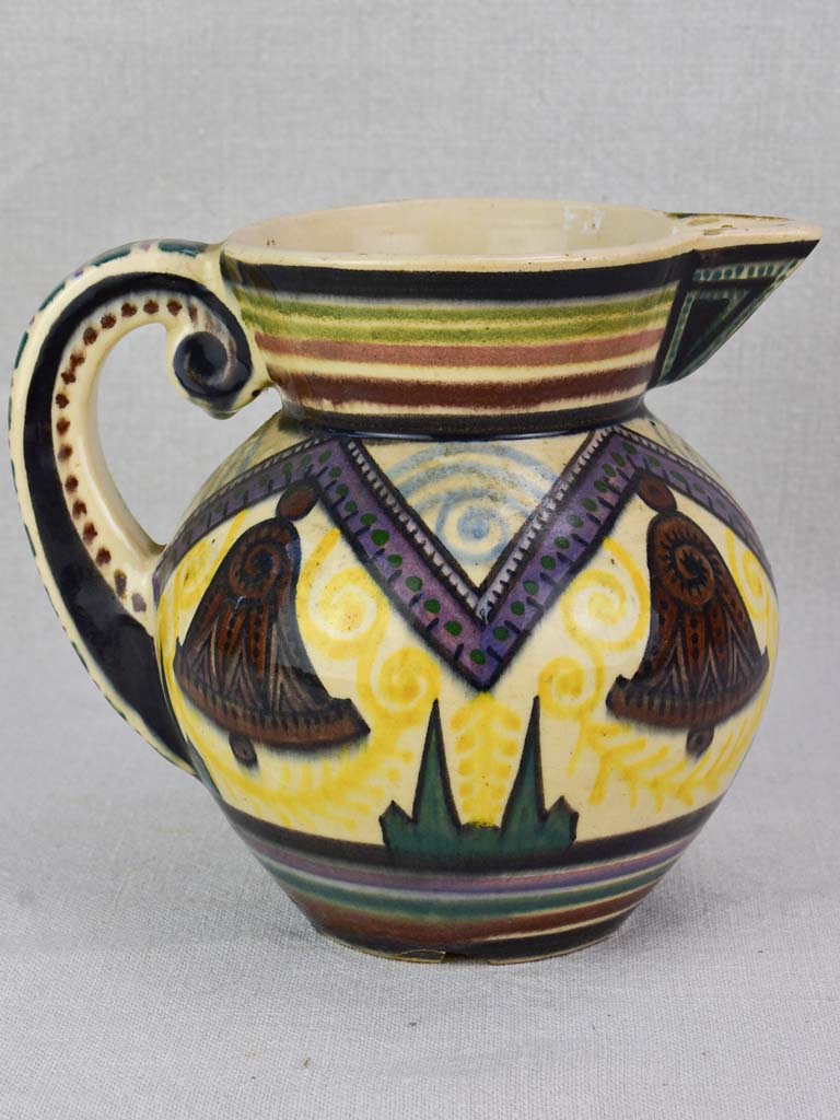 Mid-century Quimper pitcher decorated with bells and trees