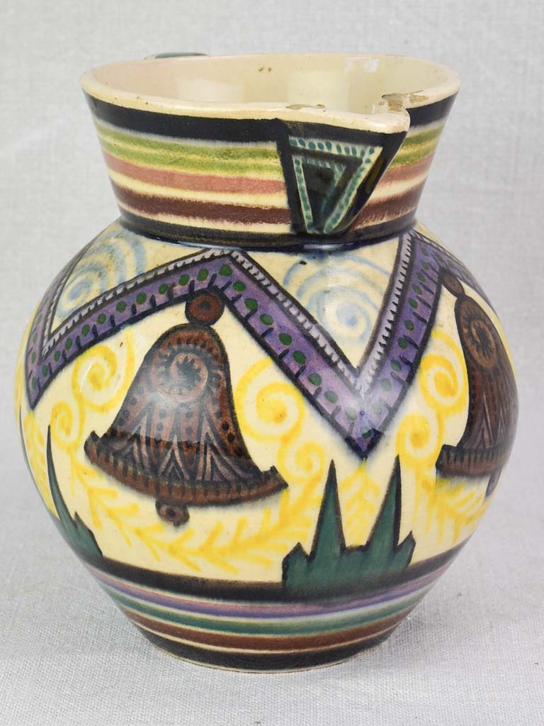Mid-century Quimper pitcher decorated with bells and trees