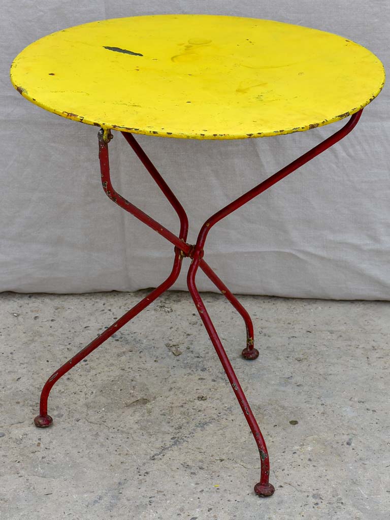 Folding antique French garden table with yellow table top and red legs