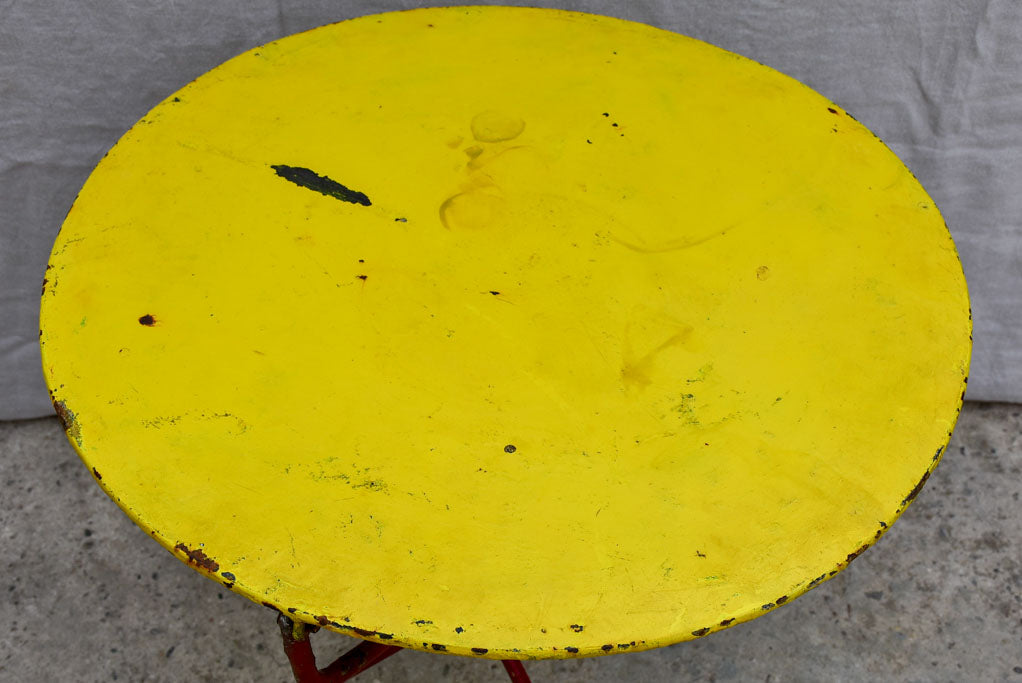 Folding antique French garden table with yellow table top and red legs