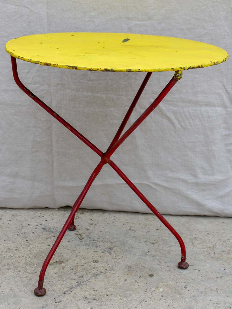 Folding antique French garden table with yellow table top and red legs