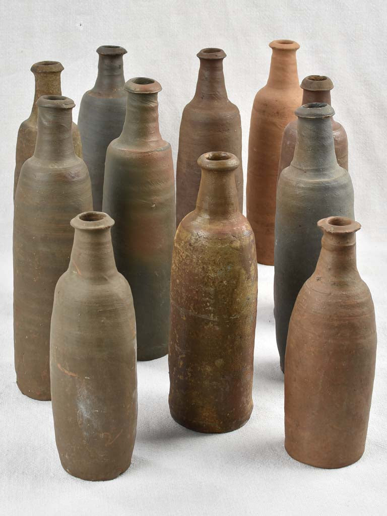 Collection of 11 antique Ger sandstone long bottles 11¾"