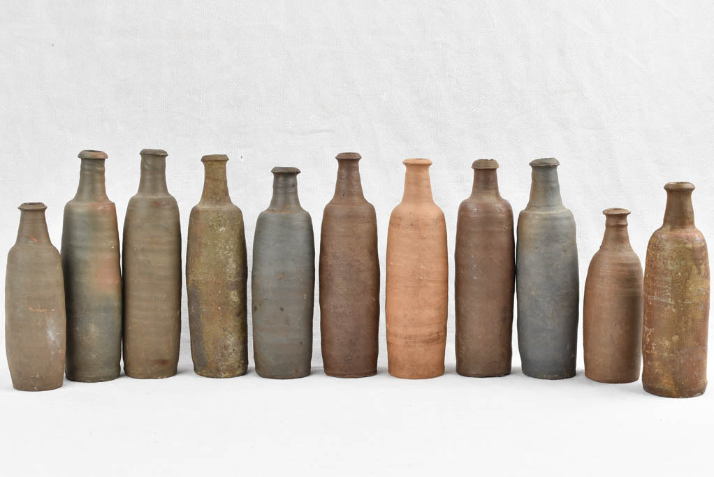 Collection of 11 antique Ger sandstone long bottles 11¾"