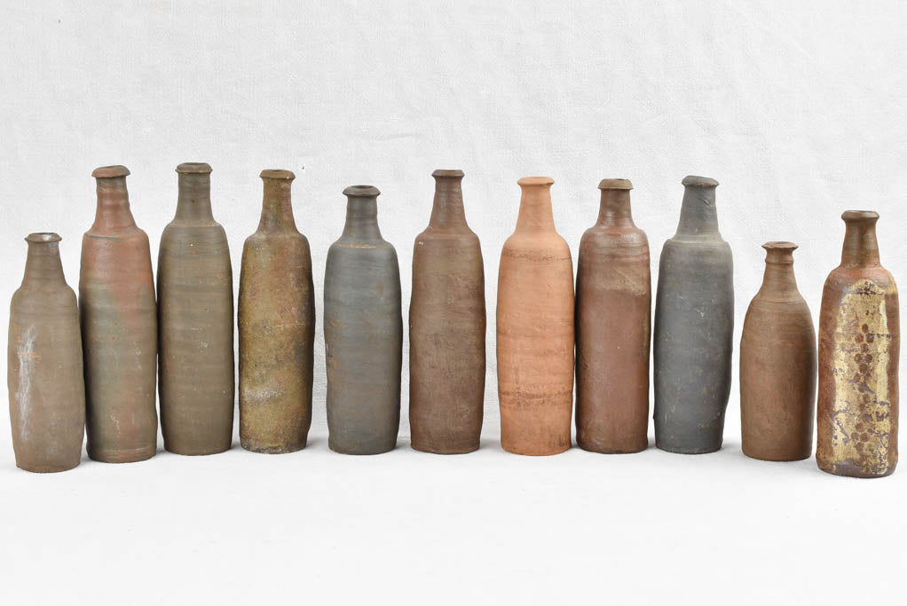 Collection of 11 antique Ger sandstone long bottles 11¾"