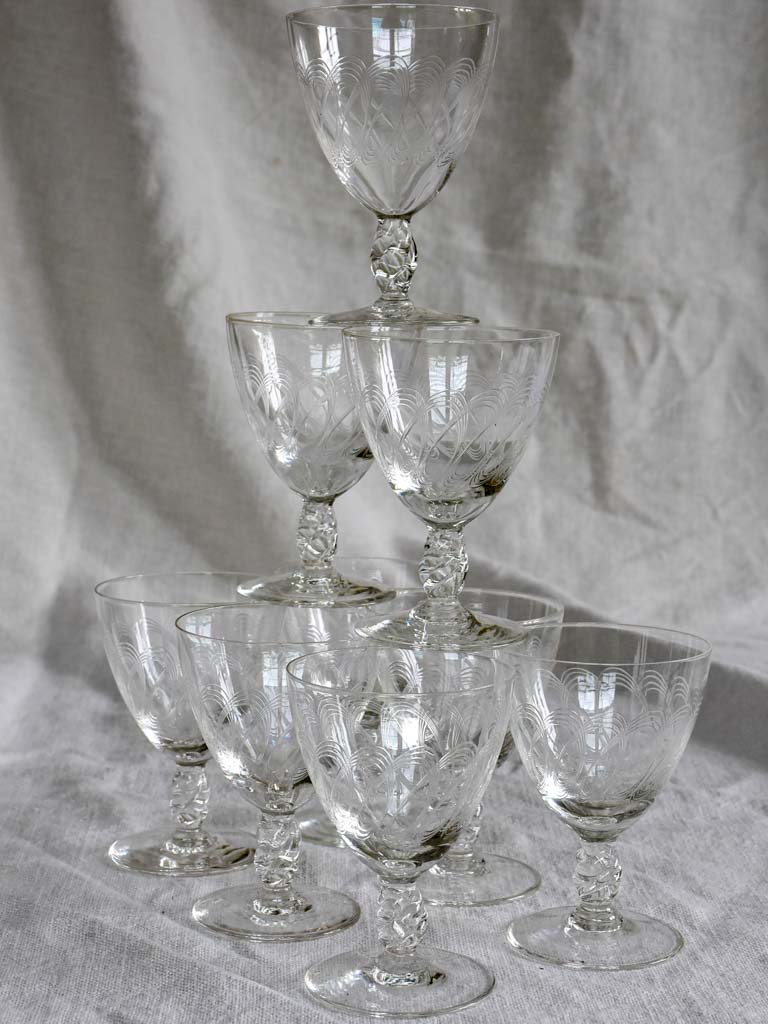 Nine mid-century white wine glasses with pretty engraving