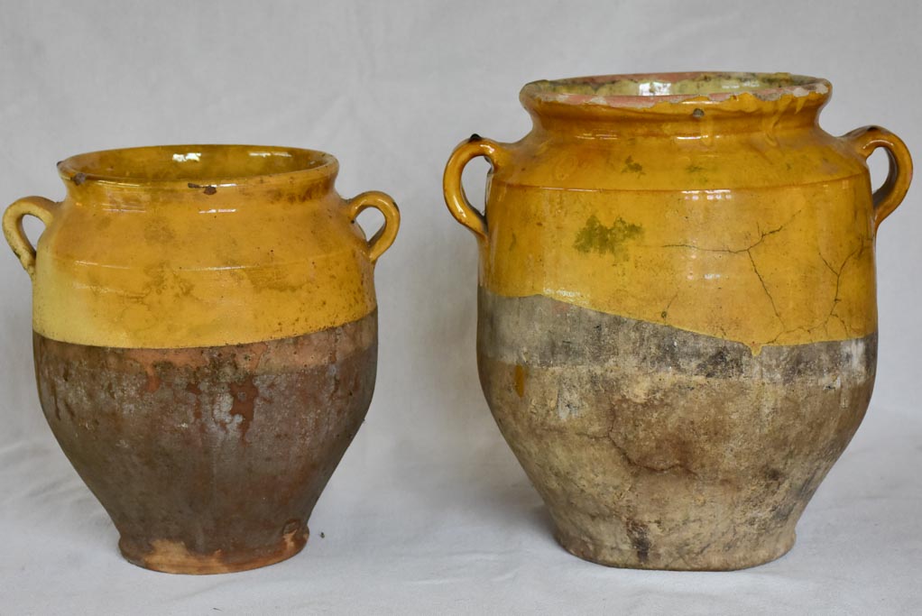 Two large antique French confit pots with yellow glaze