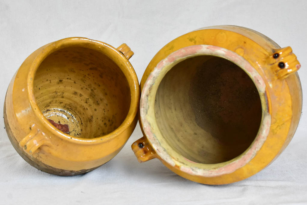 Two large antique French confit pots with yellow glaze