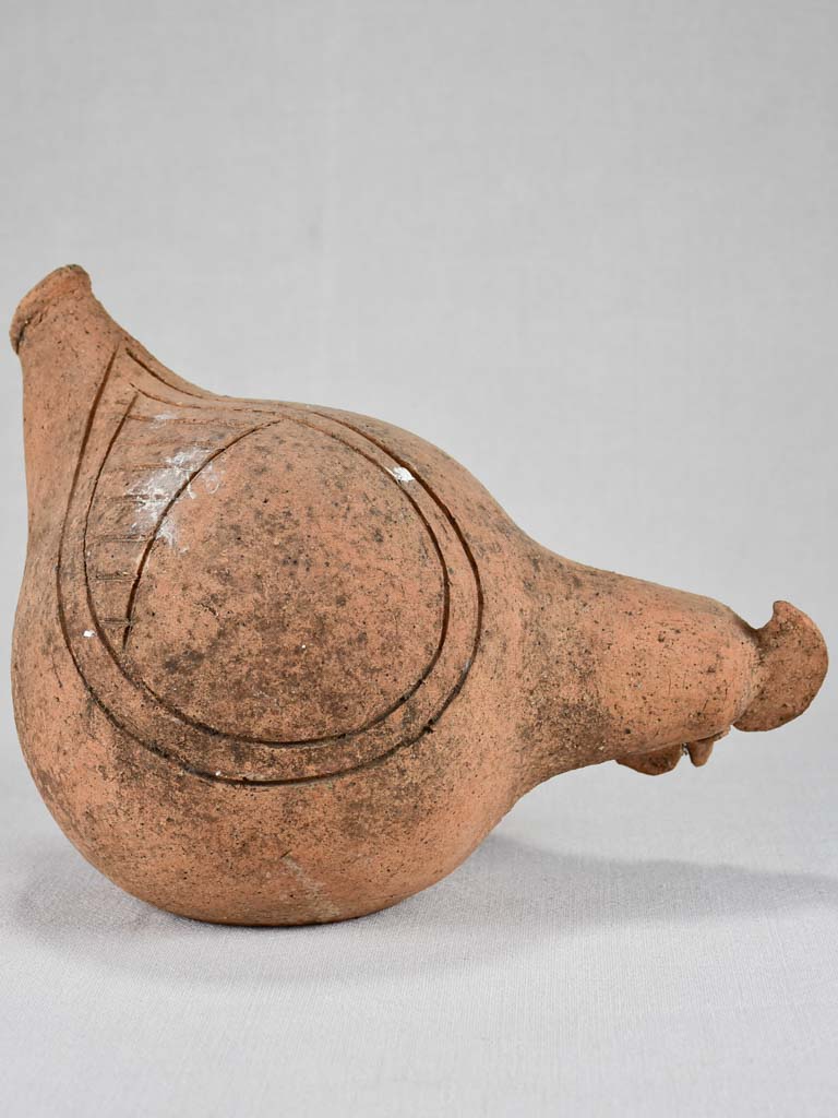 Vintage clay sculpture of a foraging chicken