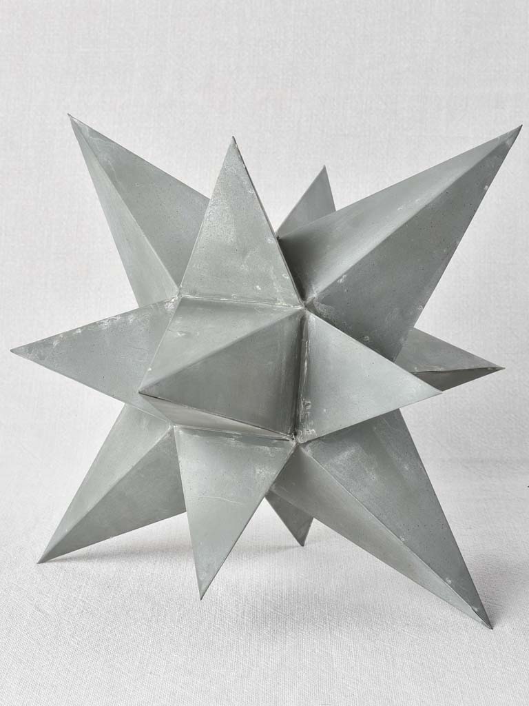 Collection of four early 20th century zinc stars 3½" - 10¼"