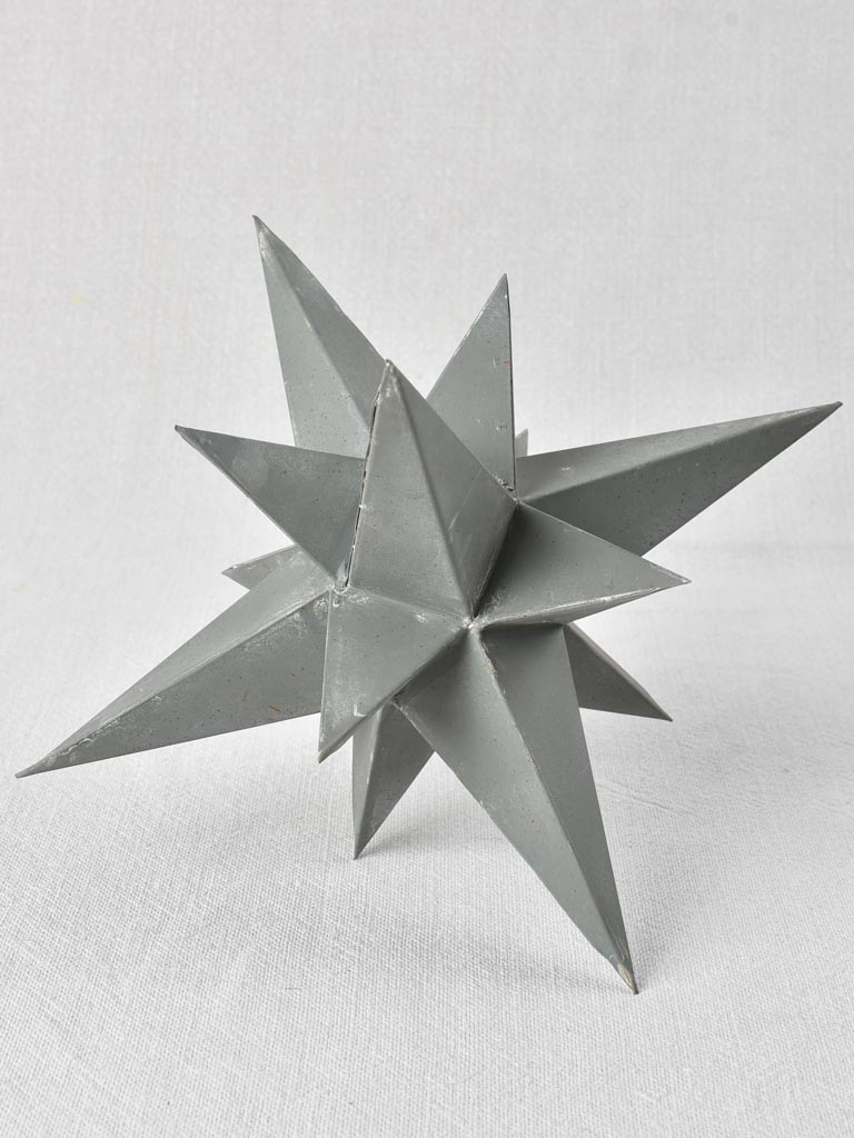 Collection of four early 20th century zinc stars 3½" - 10¼"