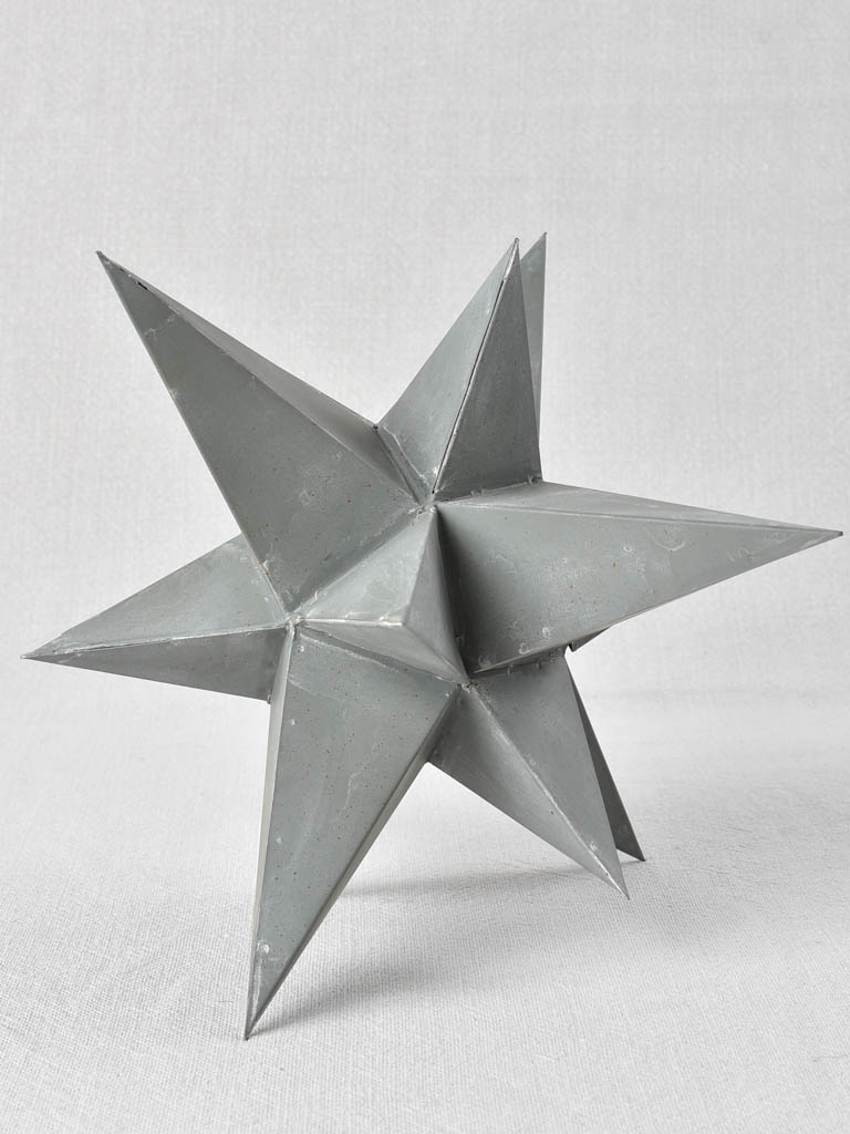 Collection of four early 20th century zinc stars 3½" - 10¼"