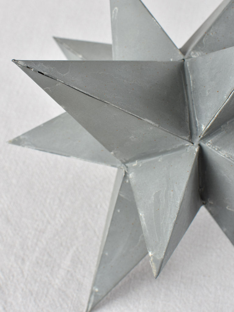 Collection of four early 20th century zinc stars 3½" - 10¼"
