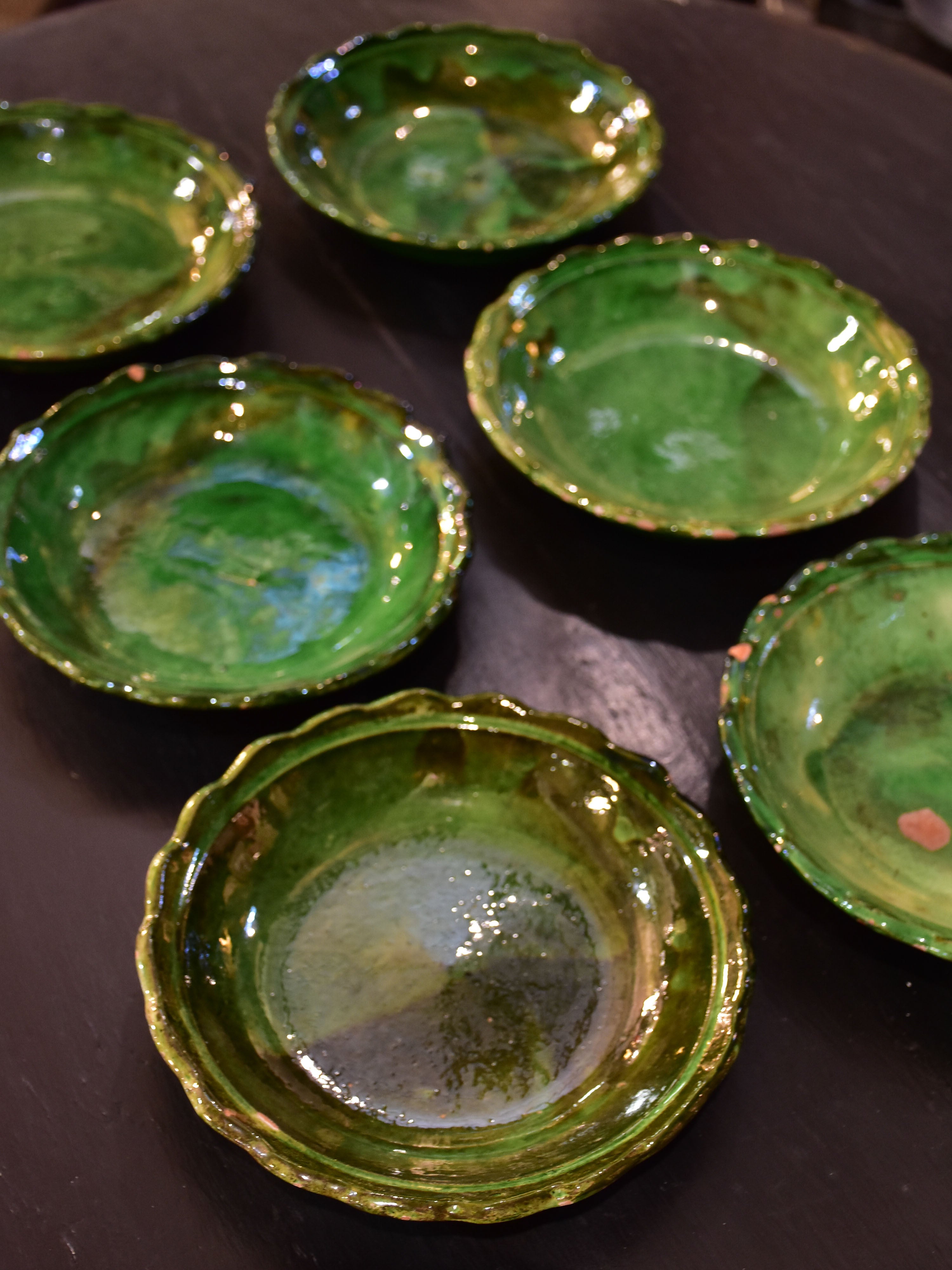 Set of six green glazed Provencal earthenware plates