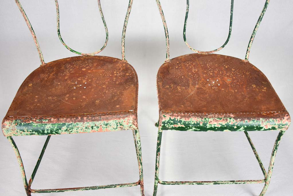Pair of rustic French garden chairs with green patina