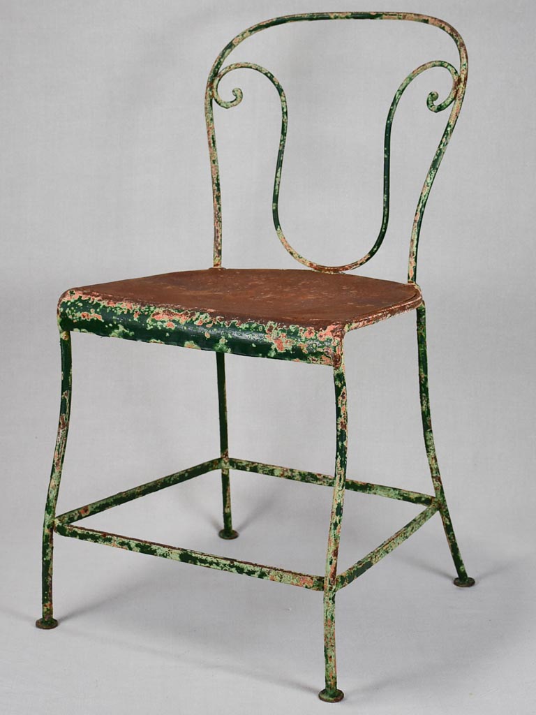 Pair of rustic French garden chairs with green patina