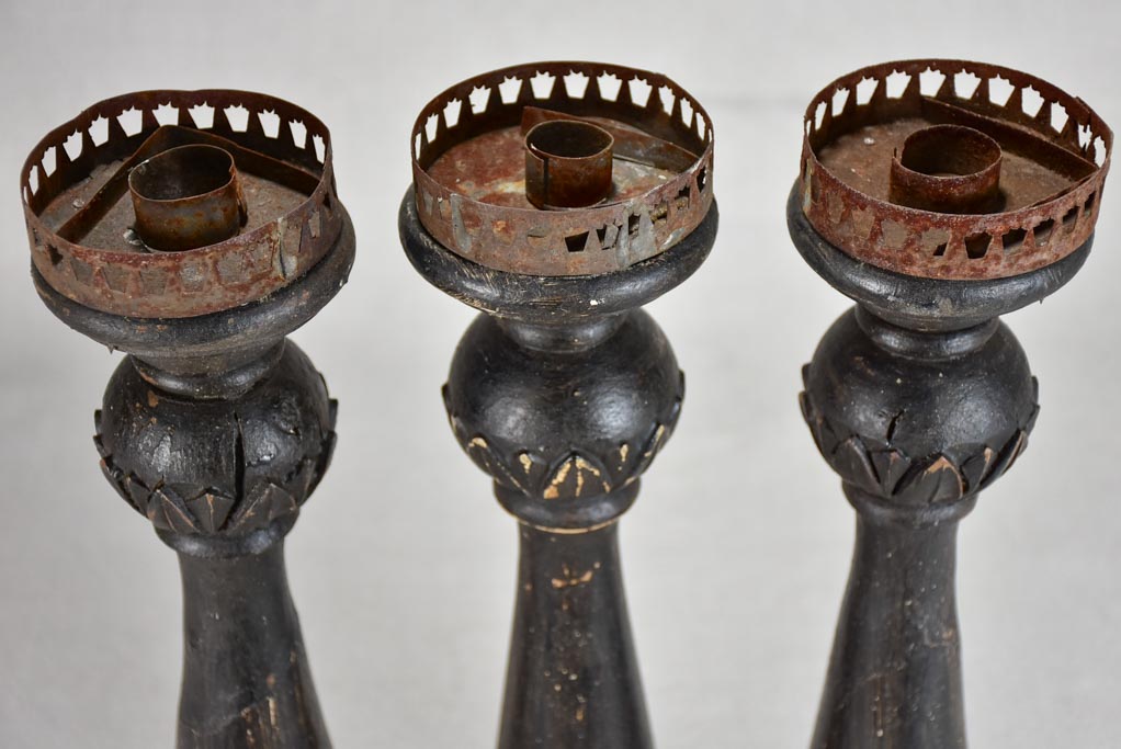 Three twentieth-century French wooden candlesticks with black paint finish 15"