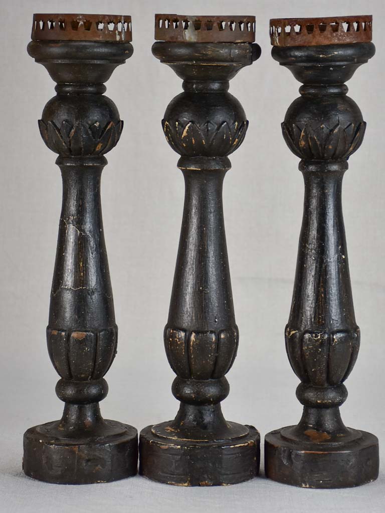 Three twentieth-century French wooden candlesticks with black paint finish 15"