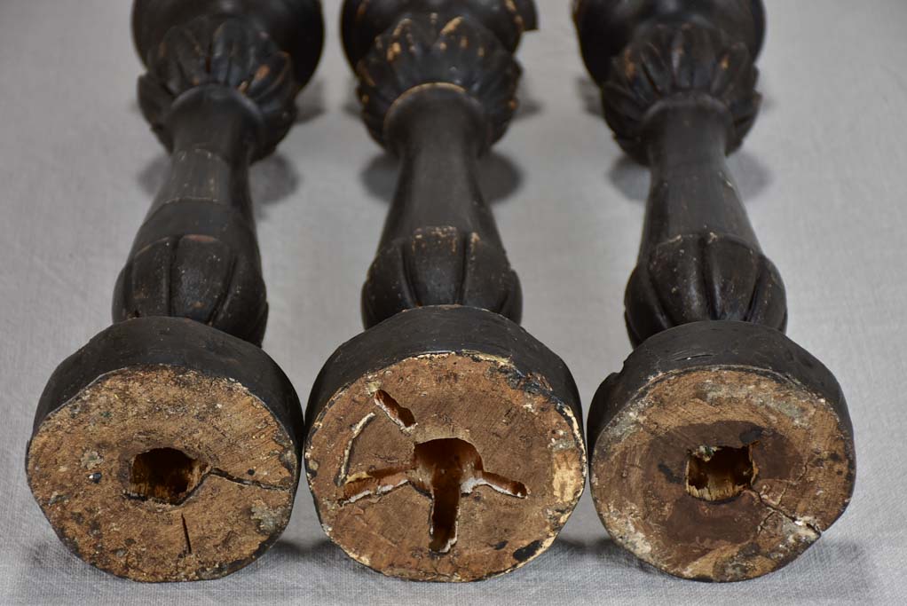 Three twentieth-century French wooden candlesticks with black paint finish 15"