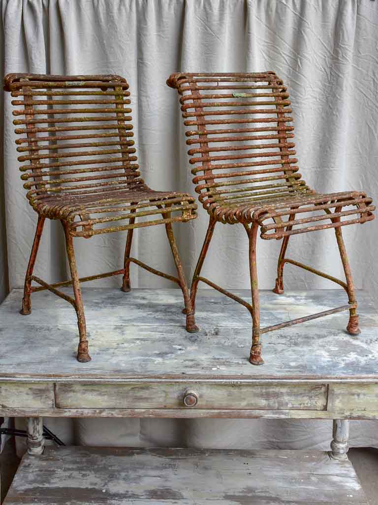 Pair of antique French Arras garden chairs with scrolled edges