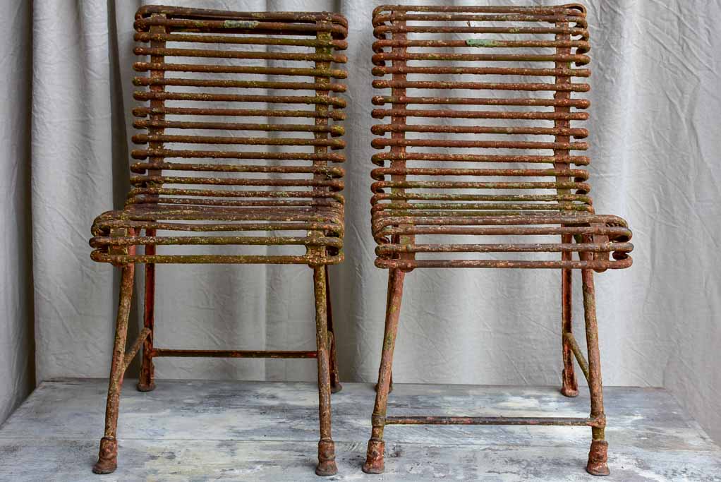 Pair of antique French Arras garden chairs with scrolled edges