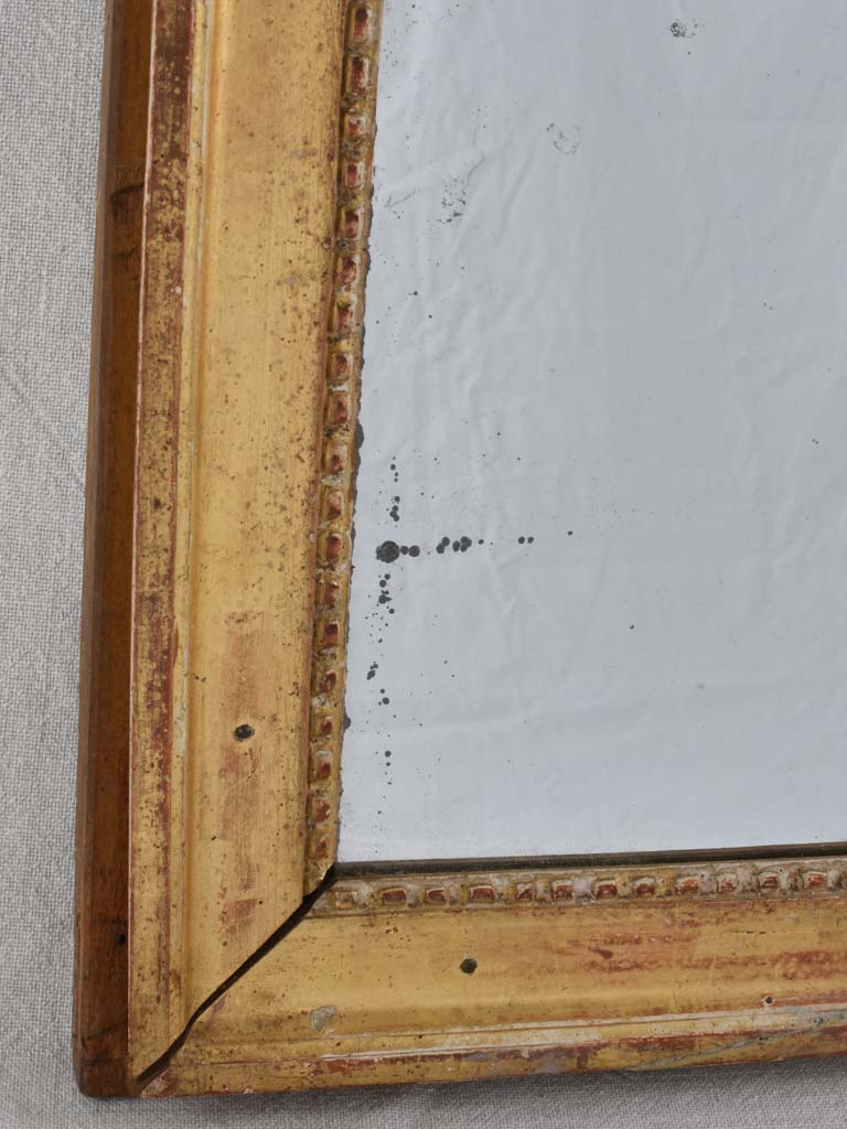 Gilded Louis XVI mirror with running pearl and mercury glass 28" x 20¾"