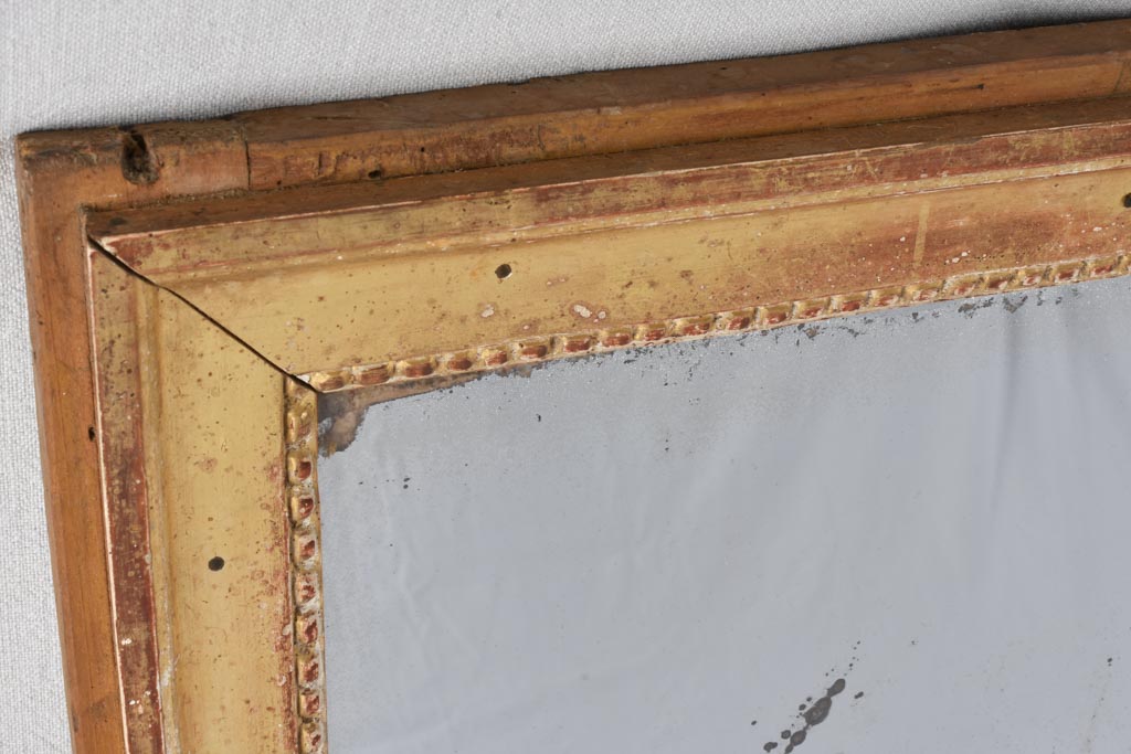 Gilded Louis XVI mirror with running pearl and mercury glass 28" x 20¾"