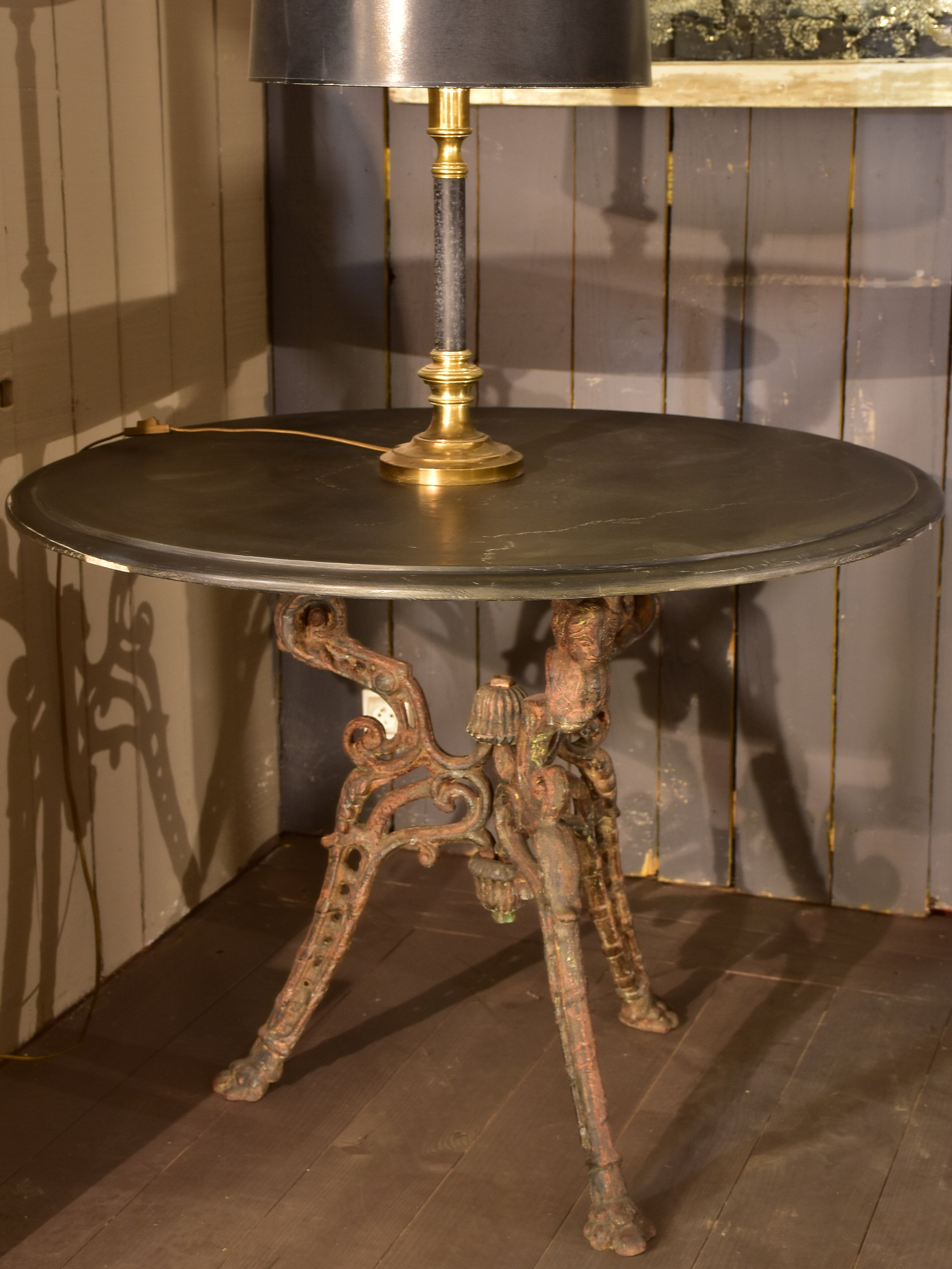 Large round table with cast iron legs and slate table top