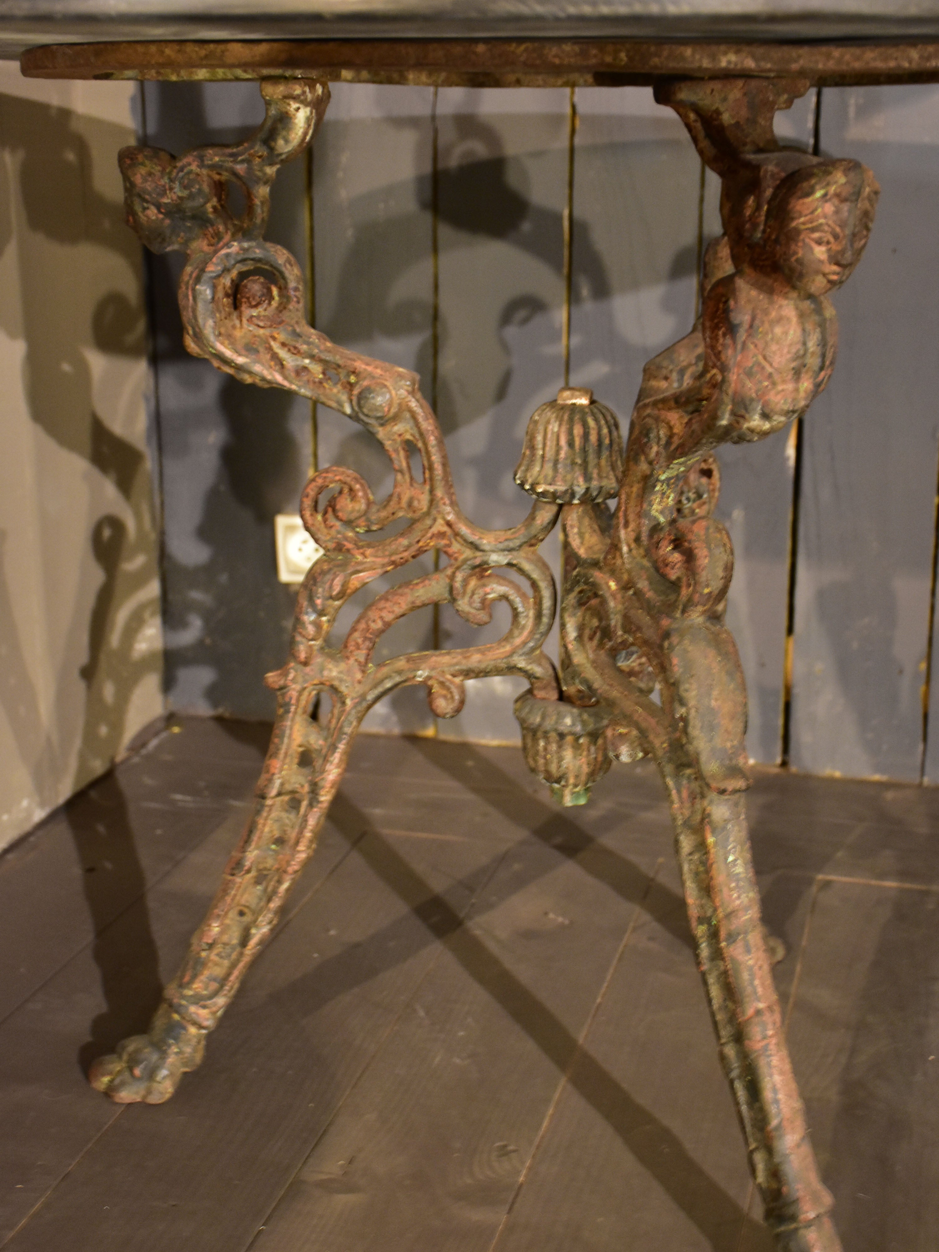 Large round table with cast iron legs and slate table top