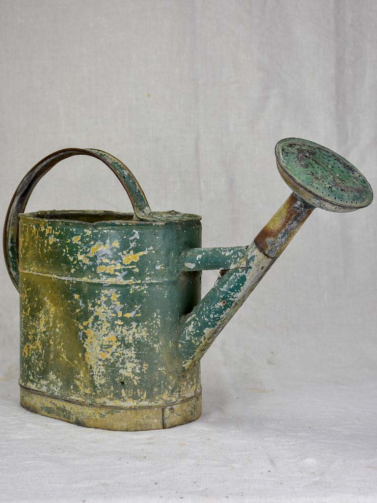 Antique French watering can with green patina