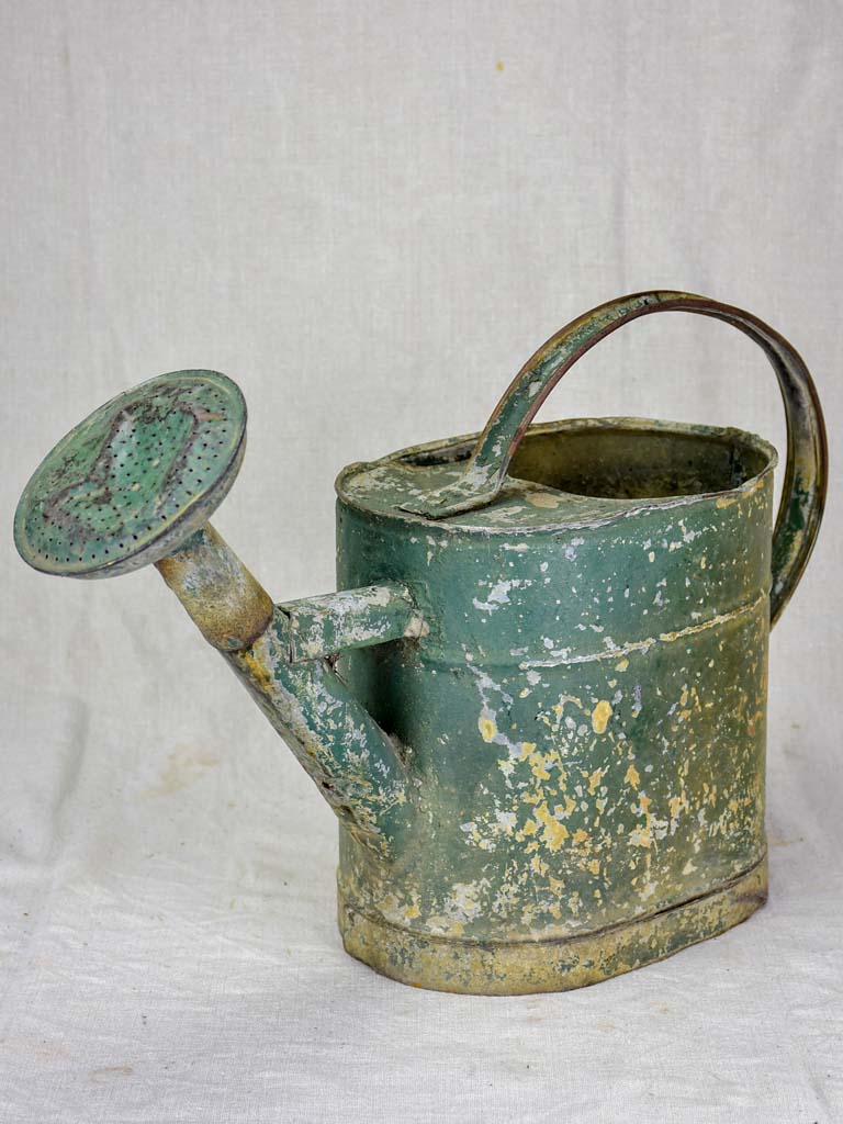Antique French watering can with green patina