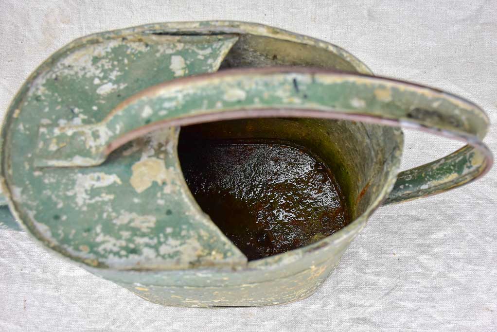 Antique French watering can with green patina